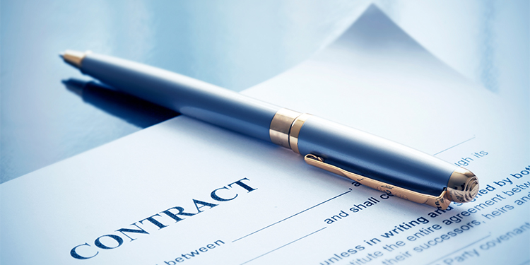 Contract and pen on table.