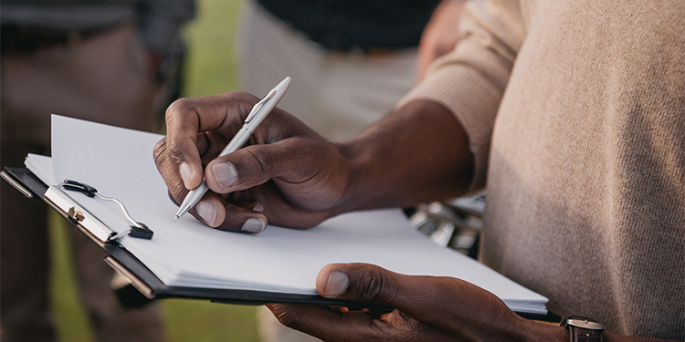 Entrepreneur with a buying a business checklist.
