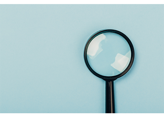 Magnifying glass on blue background.