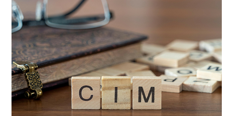 The acronym "CIM" spelled out with Scrabble tiles.