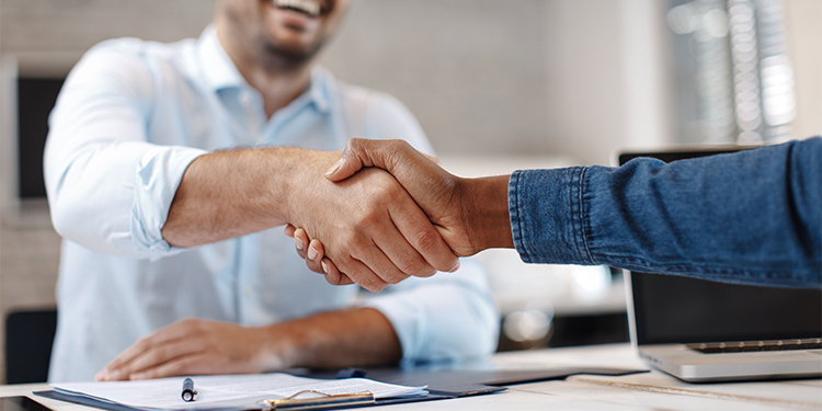 Two business men shaking hands.