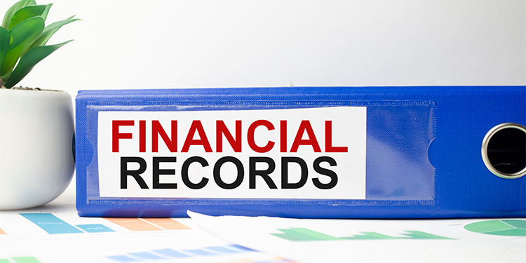 Financial records label on blue binder.
