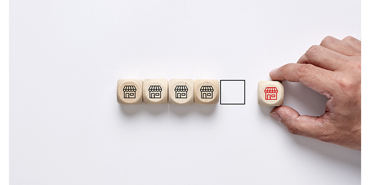 Franchise sale depicted in wooden blocks with one block being removed from the group.