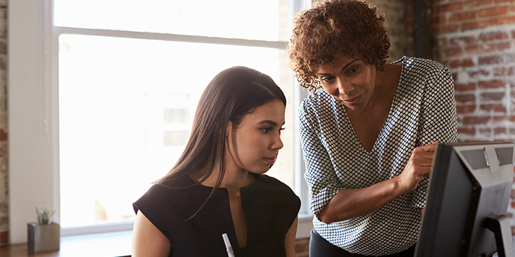 Business owner mentoring employee. 