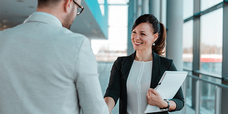 Valuation professional shaking business owner's hand.