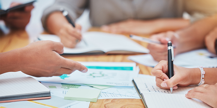Writing copy for advertising and marketing at a conference table. 